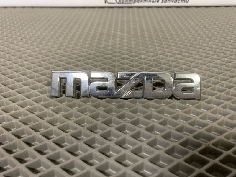 Эмблема Mazda Demio DW3W