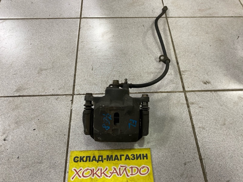 Суппорт Toyota Ist NCP60 2NZ-FE 05.2002 передний левый (б/у)