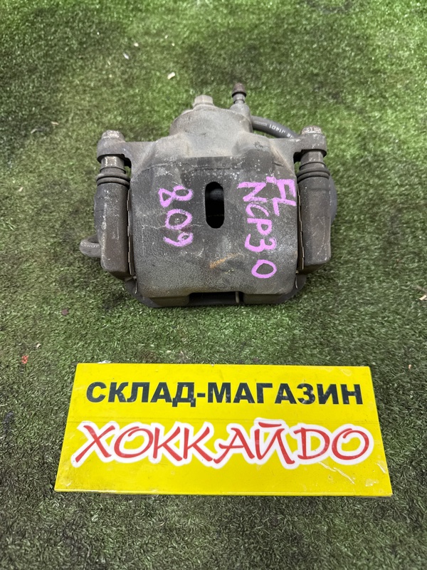 Суппорт Toyota BB NCP30 2NZ-FE 04.2003 передний левый (б/у)