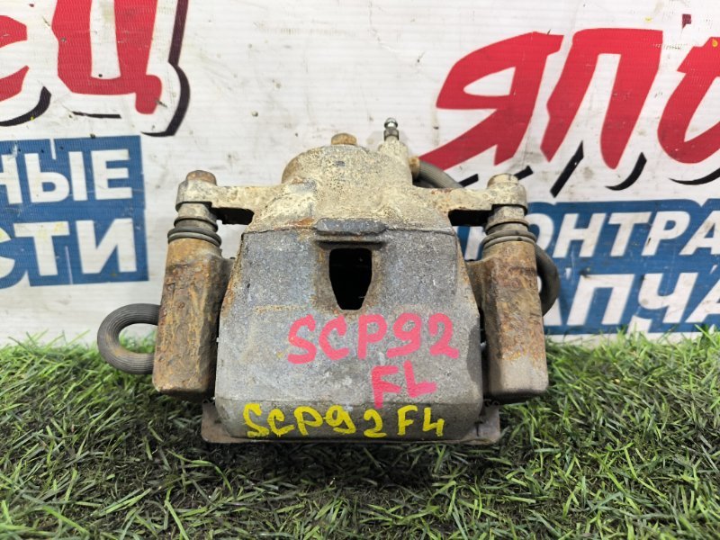 Суппорт TOYOTA BELTA SCP92 2SZ-FE передний левый (б/у) Суппорт TOYOTA BELTA SCP92 2SZ-FE передний левый (б/у)