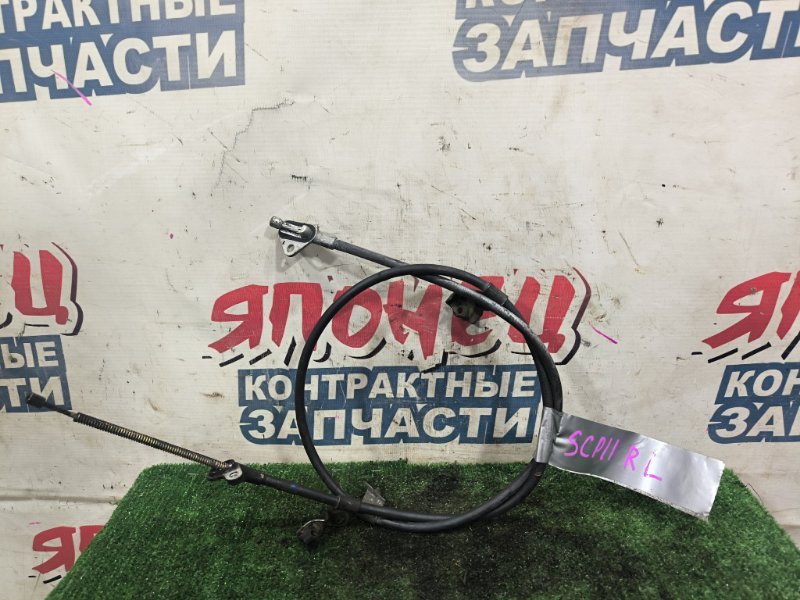 Тросик ручника TOYOTA PLATZ SCP11 1SZ-FE задний левый (б/у)