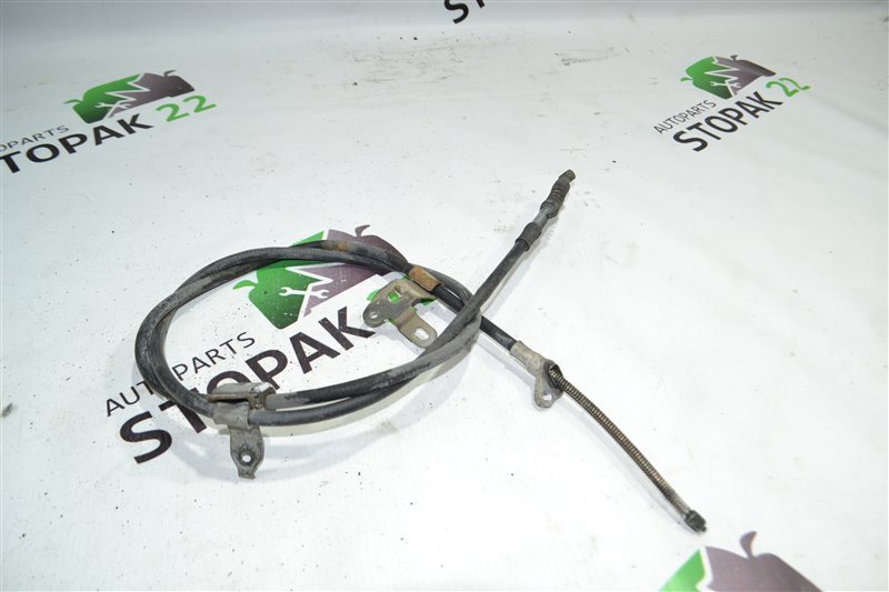 Трос ручника Toyota Corolla NZE121 1NZ 2002 задний левый (б/у) Трос ручника Toyota Corolla NZE121 1NZ 2002 задний левый (б/у)