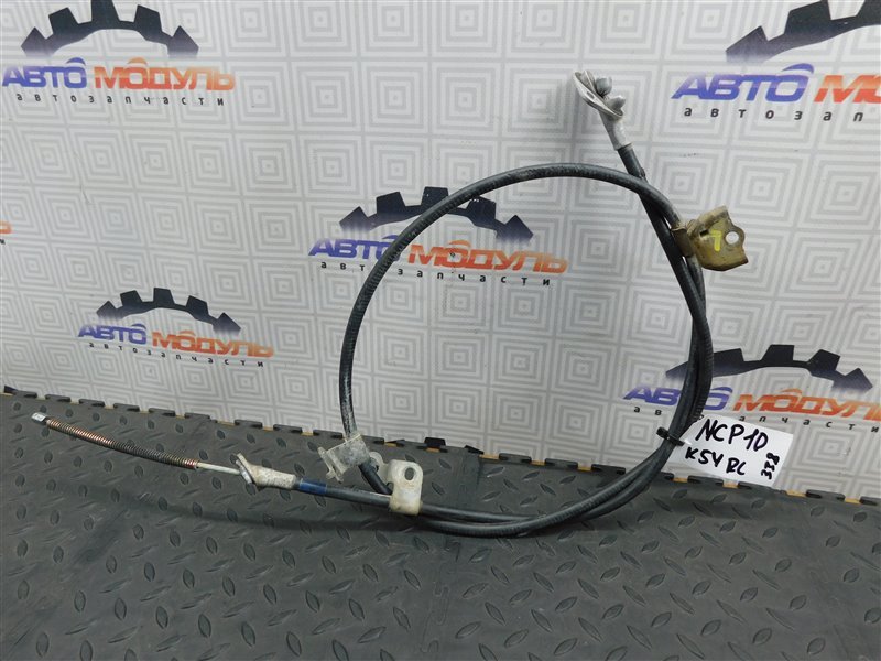 Тросик ручника TOYOTA VITZ NCP10-0157699 2NZ-FE 2002 задний левый (б/у)