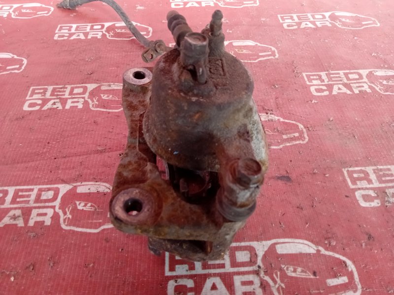Суппорт передний левый TOYOTA RACTIS NCP105-0024969 1NZ-5366184