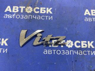 Эмблема задняя Toyota Vitz 2010- контрактная Эмблема задняя Toyota Vitz 2010-