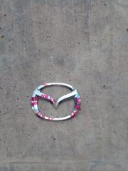 Запчасть эмблема передняя MAZDA CAROL 2009-2014