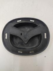 Фото запчасти кронштейн эмблемы решетки радиатора Mazda 6 Б/У запчасть Запчасть кронштейн эмблемы решетки радиатора Mazda 6