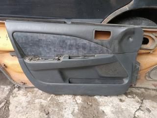 Обшивка двери передняя левая Toyota Carina