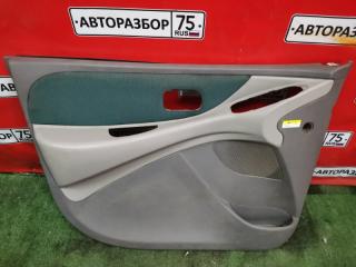 Обшивка двери передняя левая NISSAN TINO 1998